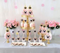 a table topped with lots of cakes and cupcakes