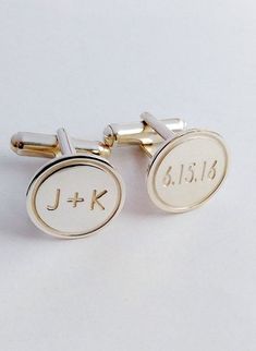 two cufflinks with the initials j - k and f - k on them