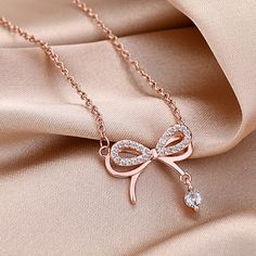 Fashion Element: Bow Style: Simple Rose Gold Alloy Chain Jewelry, Rose Gold Alloy Jewelry With Chain Detail, Rhinestone Chain Necklace Metal Gift, Delicate Chain Rose Gold Alloy Jewelry, Rose Gold Alloy Jewelry With Delicate Chain, Delicate Rose Gold Alloy Chain Jewelry, Alloy Charm Necklace As Gift, Adjustable Rose Gold Chain Necklace, Adjustable Alloy Rhinestone Pendant Necklace