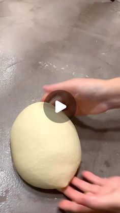 a person is kneading a ball of dough