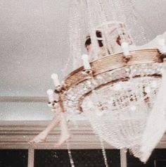 a chandelier hanging from the ceiling in a room with two women on it