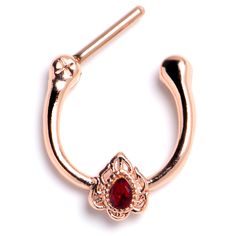 a gold nose ring with a red stone