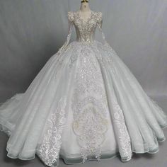 a white ball gown with long sleeves and beading