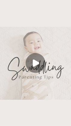 a baby laying on top of a bed with the words sanddling in front of it