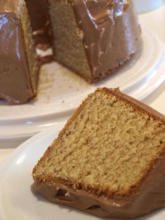 two plates with slices of cake on them and one has chocolate frosting in the middle