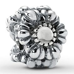 a silver beaded ring with flowers on it's center and an oval hole in the middle