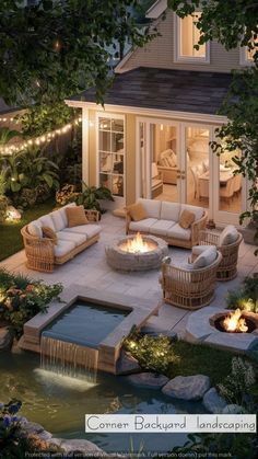 an outdoor patio with fire pit and seating around it at night, surrounded by greenery