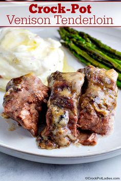 a white plate topped with meat and mashed potatoes