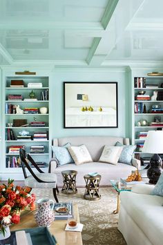 a living room filled with furniture and bookshelves