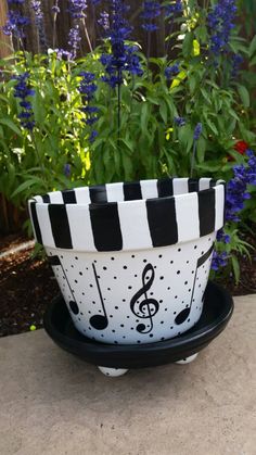 a black and white bowl with musical notes painted on it