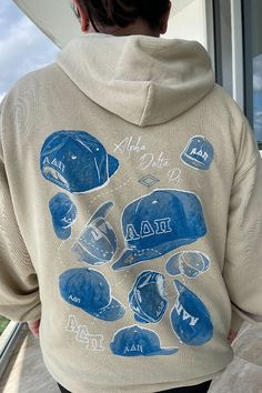 the back of a person wearing a hoodie with blue baseball caps on it,