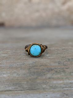 Urban boho wire Wrapped Ring Made with a 10mm Turquoise magnesite gemstone coin bead. The ring is wrapped with 18 gauge non tarnish wire. Your choice of antique brass or silver plated wire. Rings are made to order in your size. Ring may appear larger in photos to show detail. Since each ring is handmade and gemstones vary in color tone and pattern, there may be slight differences in each ring. Your order will be made and shipped within 1-5 business days of received payment. Returns and exchanges Turquoise Wire Wrapped Round Jewelry, Adjustable Turquoise Bohemian Ring, Bohemian Hand Forged Turquoise Ring, Hand Forged Adjustable Bohemian Rings, Bohemian Adjustable Hand Forged Rings, Adjustable Hand Forged Bohemian Rings, Bohemian Hand Forged Ring, Bohemian Hand Forged Round Ring, Bohemian Turquoise Wire Wrapped Rings