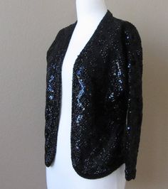 "Vintage 1950s/60s Italian Couture Laura Aponte Black Sequined 100% Pure Wool Cardigan/Jacket, ¾ Sleeves Every time I look at this I think of Liza Minnelli! I found this item zipped up in a vinyl pouch at an estate sale. It is truly stunning. 100% pure wool in black fully adorned in black sequins in a diamond pattern. In excellent vintage condition. Laura Aponte designed for Schiaparelli before starting her own couture house in Italy sometime in the 50s. Some of her designs are currently held as Fitted Sequin Evening Cardigan, Vintage Blazer For Spring Party, Vintage Winter Party Blazer, Vintage Party Blazer For Winter, Vintage Evening Blazer For Winter, Retro Evening Outerwear For Fall, Retro Fall Evening Outerwear, Fitted Open Front Cardigan For Party, Retro Fitted Party Blazer