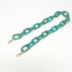 Your handbag game is about to step up a notch! Mix and match any one of our bag straps with your favorite party box or bring new life to the bags you already own and love. All bags and straps sold separately so you can customize. Features an oval chain strap in turquoise with gold toned oversized lobster clasp. ▪️Length: 25.5", Width: 1"▪️Materials: acrylic, plated metals. Accessories curated for Closet Rehab. Green Adjustable Rectangular Bag Strap, Trendy Handmade Rectangular Bag Strap, Trendy Green Bag Strap For Everyday, Handmade Rectangular Trendy Bag Strap, Trendy Green Everyday Bag Strap, Turquoise Rectangular Bag With Detachable Strap, Rectangular Turquoise Bag With Detachable Strap, Adjustable Rectangular Bag Strap, Trendy Blue Bag Strap For Everyday