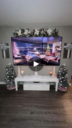 a flat screen tv mounted to the side of a wall in a living room with christmas decorations