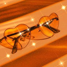 a pair of heart - shaped sunglasses is reflected in the sun's glares