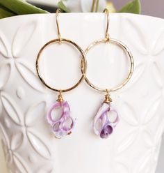 "Handmade round hoops and purple cebu shells. Round hoops are about 1 inch and slightly hammered for textures and shine. Sliced cebu shells are measure about 14 x20mm in sizes Earrings total length is about 2\" including ear wires. PLEASE NOTE: Shells are vary in shapes and size due to availability." Adjustable Purple Hoop Earrings, Adjustable Purple Round Hoop Earrings, Nickel-free Purple Hoop Earrings, Purple Dangle Earrings For The Beach, Purple Dangle Earrings For Beach, Purple Drop Earrings For The Beach, Handmade Purple Teardrop Hoop Earrings, Purple Drop Earrings For Beach, Purple Handmade Small Hoop Earrings