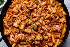 pasta with shrimp and tomato sauce in a skillet