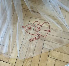 two hearts are drawn on the floor with veils