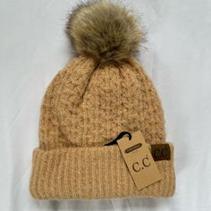 Description: ~ Nwt!! Never Worn ~ Knit Stitch Pattern Beanie With Faux Fur Pom ~ Head Measurements: 57 Cm, 22-3/8", Size 7-1/19. ~ Unisex Knitted Beanie ~ C.C Patch Stitched On Front ~ Color: Peanut ~ Fuzzy Inside ~ 65% Acrylic 12% Nylon 1% Spandex Beige Knit Beanie, Brown Knit Beanie, Trendy Beige Beanie For Fall, Beige Knit Beanie For Cold Weather, Cute Brown Winter Beanie, Beige Beanie For Fall Cold Weather, Casual Beige Knit Beanie, Knitted Beanie, Knit Stitch Patterns