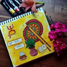 an art journal with flowers and pens on the table