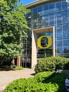 the entrance to an office building with a large yellow o on it's side