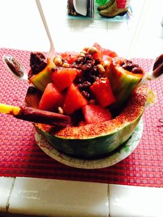 a bowl filled with fruit and nuts on top of a table