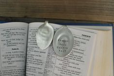 two spoons sitting on top of an open book with the word god is love written on it