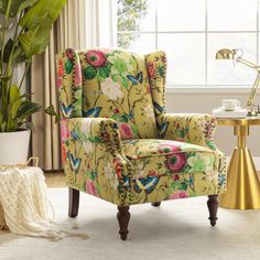 a living room with a yellow chair and potted plant in the corner next to it