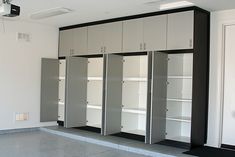 an empty room with white and black cabinets