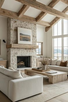 a living room filled with furniture and a fire place in front of a large window