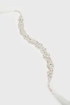 The Lulus Sweetest Ending Silver Rhinestone Bridal Belt is the perfect touch for your special day! Look absolutely gorgeous with this belt that features sparkling, clear glass rhinestones (in silver settings) that shape an abstract, floral-inspired design. Sheer ribbons tie together at the back for an elegant finish. 88" Long. Embellishment Measures 18" Long And 1. 25" Wide. 45% Copper, 45% Glass, 10% Polyester. Imported. Lulus | Sweetest Ending Silver Rhinestone Bridal Belt. Elegant Bedazzled Silver Bridal Accessories, Elegant Silver Bedazzled Bridal Accessories, Glamorous Bedazzled Jewelry For Wedding, Adjustable Silver Crystal Bridal Belt, Adjustable Rhinestone Bridal Accessories, Adjustable Bridal Accessories With Rhinestones, Elegant Bedazzled Crystal Jewelry, Adjustable Crystal Bridal Belt With Rhinestones, Adjustable Bridal Belt With Rhinestones And Crystal