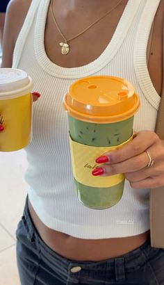 a woman holding a coffee cup with her hands