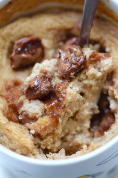 a close up of a bowl of food with a spoon in it