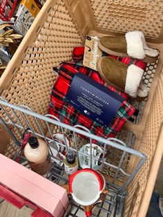 a shopping cart filled with lots of items like slippers, mugs and socks