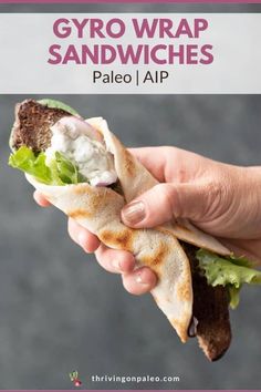 a person holding up a sandwich with text overlay that reads palen, freeze - friendly aip gyro wrap sandwich