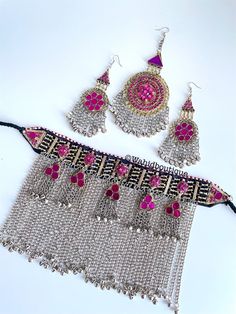 Afghan vintage Pink 3 piece kuchi jewellery set,kuchi necklace,  Afghan jewellery, Afghan Fashion,  Set includes:  -1 pair of oversized earrings  -1 necklace  -1 tikka  Message for any inquiries Our Aim as a business is to connect Afghan women with their roots and to make anyone that purchases our jewellery feel powerful and beautiful as each and everyone of our items is handcrafted with care and love. Vintage Pink Jewelry For Festivals, Bohemian Metal Jewelry Sets For Festivals, Bohemian Jewelry Sets For Festivals, Handmade Pink Jewelry Sets For Festivals, Bohemian Tilla Jewelry Sets For Festivals, Traditional Handmade Pink Jewelry Sets, Pink Bohemian Jewelry For Festivals, Vintage Metal Jewelry Sets For Festival, Pink Bohemian Jewelry For Festive Occasions