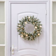 a white door with a wreath on it