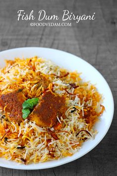 fish dum biriyani served on a white plate