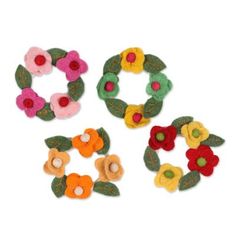 four felt wreaths with flowers and leaves on them