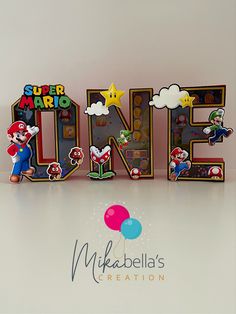 the word one is made out of paper and has mario's characters on it