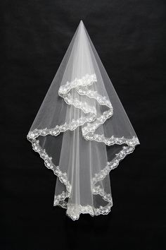 a veil with white lace on it