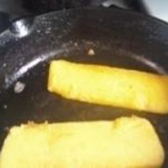 two pieces of food cooking in a frying pan