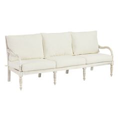 a white couch with four pillows on it