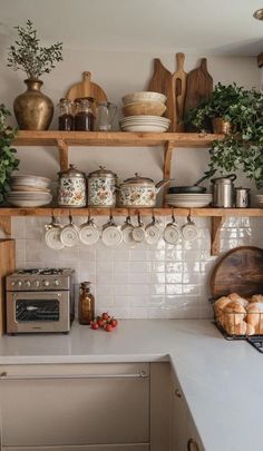 a kitchen with shelves filled with pots and pans on top of the countertop