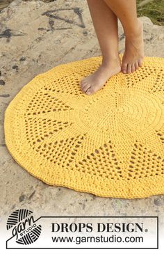 a person standing on top of a yellow doily with their feet in the center