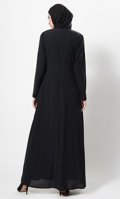 Featuring a beautiful modest wear flared asymmetrical abaya dress in nida fabirc adorned with crystal embellished motifs around the waist and pleated detailing on the upper bodice. It has flared bottom skirt, zipper closure placket at the back and pckets on the sides. Its a trendy and classic ensembl perfect to be worn for evening ocassions.FIT : Relaxed fit.COMPOSITION : Nida.CARE : Dry clean only. Skirt Zipper, Abaya Dress, Modest Wear, Lace Detail, Bodice, High Neck Dress, Relaxed Fit, Zipper, Skirt