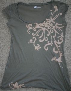 a women's t - shirt that is on the floor