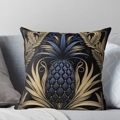 a black and gold pineapple throw pillow on a couch