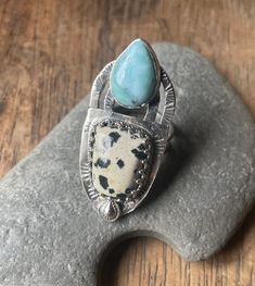 Unique one off ring. Designed and made by myself. This eye catching ring holds two beautiful stones. Blue Hemimorphite, said to promote peace and kindness while attracting playful friendships. It's paired perfectly with Dalmatian Jasper which is thought to inspire faith and devotion in others, while the black tourmaline spots are said to help with psychic protection. The ring is comfortable to wear with an adjustable band. Luxury Multi-stone Sterling Silver Crystal Ring, Luxury Sterling Silver Multi-stone Crystal Ring, Luxury Multi-stone Crystal Ring In Sterling Silver, Luxury Multi-stone Silver Crystal Ring, Jewellery Photography, 2024 Wishlist, Psychic Protection, American Indian Jewelry, Beautiful Stones